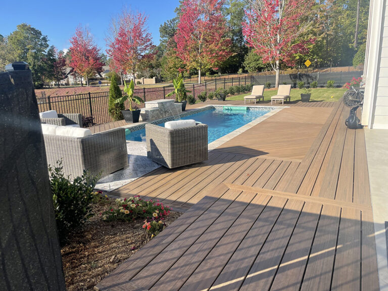 An outdoor space featuring composite deck installation materials and a swimming pool
