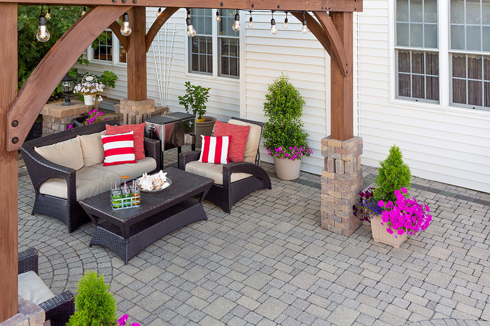 A custom brick-paved patio with comfortable patio furniture