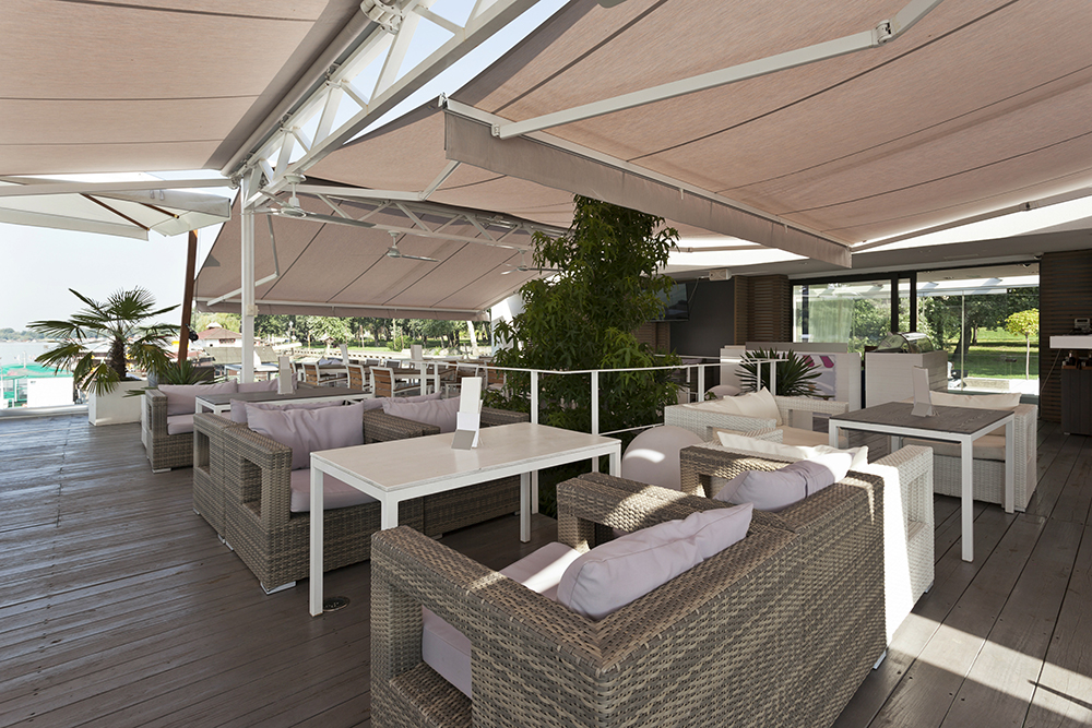 Retractable awnings and canopies at a riverside cafe