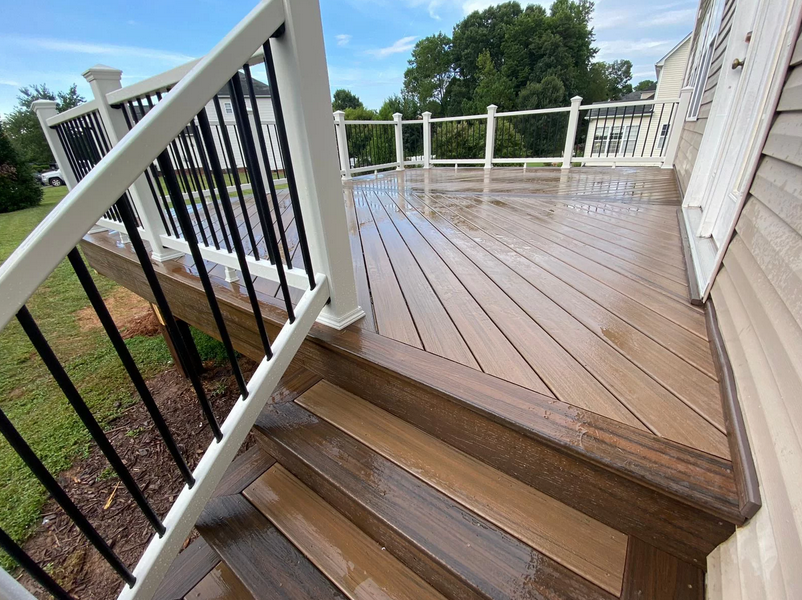 A freshly power-washed outdoor deck undergoing routine cleaning and maintenance