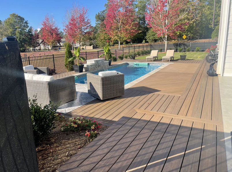 A deck, patio, and pool area built by Charlotte Deck Builders