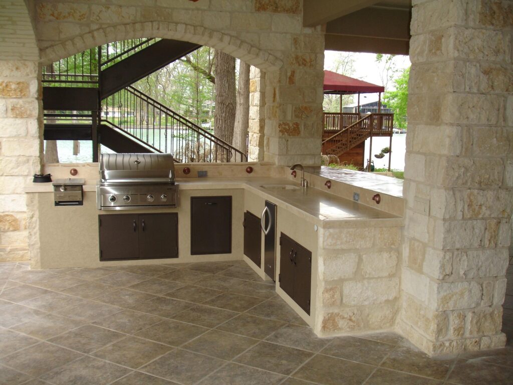 A white stone outdoor kitchen