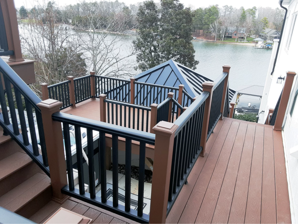 a multi-structure outdoor living project featuring a multi-level composite deck with stair landings and a lake view