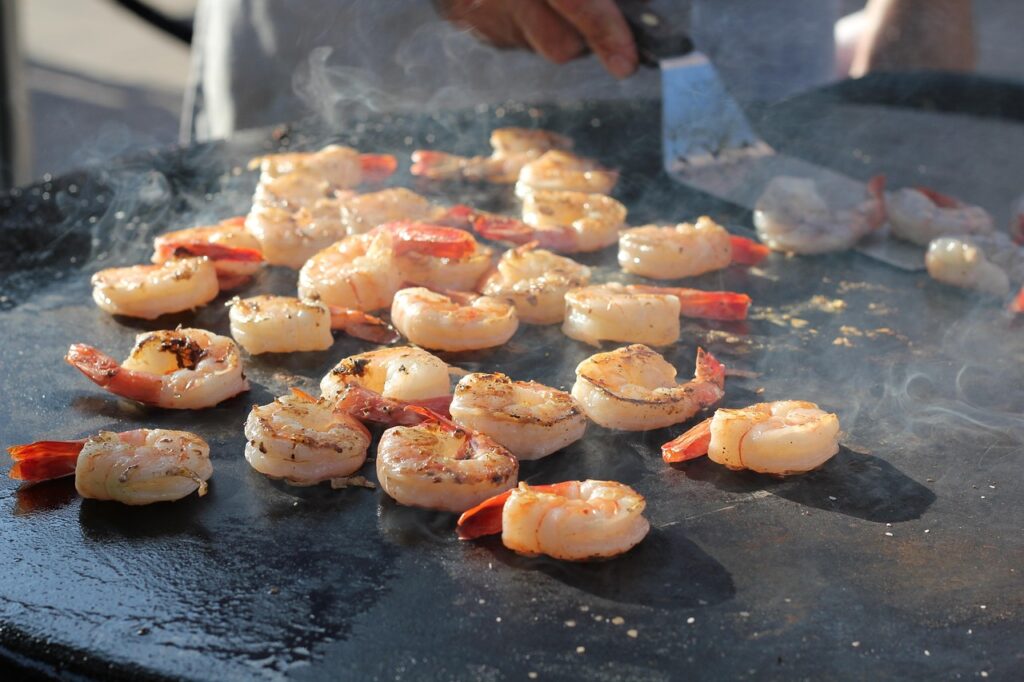 shrimp being cooked on a surface outside