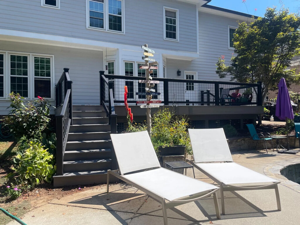 A deck behind two lawn chairs