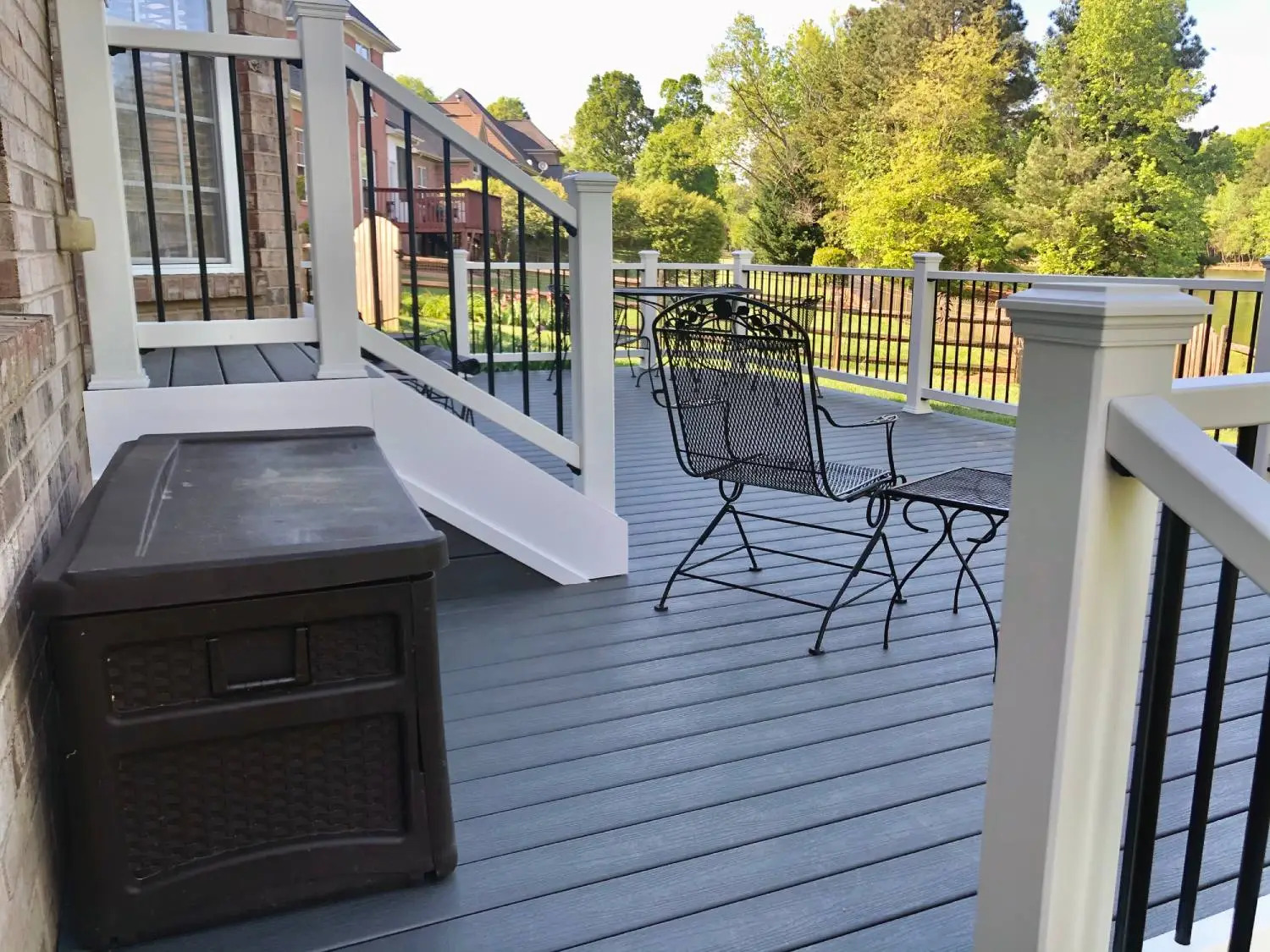 Composite deck with seating and storage space, showing how a deck size guide can help plan room for furniture, railings, and walking paths.